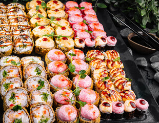 Assorted sushi platter on dark stone background