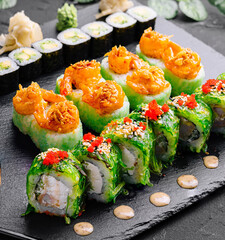 Exquisite sushi platter on dark slate background