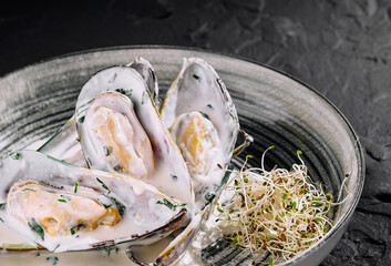 Gourmet mussels in cream sauce on elegant plate