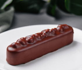 Elegant chocolate bar dessert on white plate
