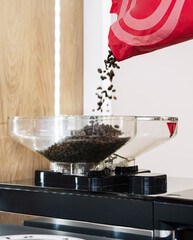 Coffee beans pouring into grinder