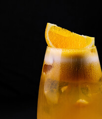 Refreshing orange cocktail on dark background