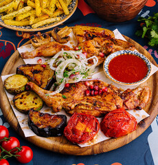 Traditional grilled chicken platter with vegetables and spices