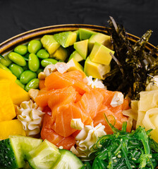 Fresh salmon poke bowl with vegetables and rice