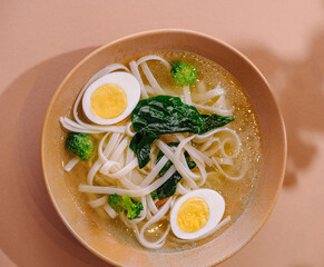 Delicious homemade udon noodle soup with egg and vegetables