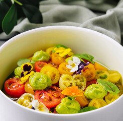 Fresh tomato salad with edible flowers