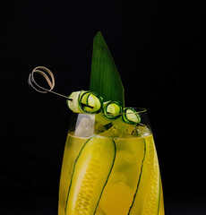 Refreshing cucumber cocktail on dark background