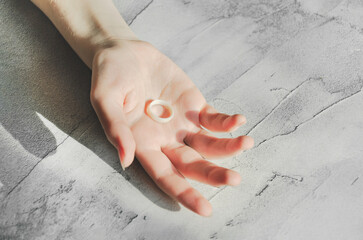 white silicone wedding ring in hand of young woman. woman's hand holding an elastic ring