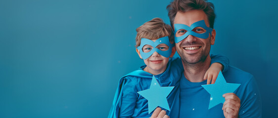 Happy Father's Day. Father and son dressed as superheroes, sharing a joyful embrace, with masks and capes, against a vibrant blue background