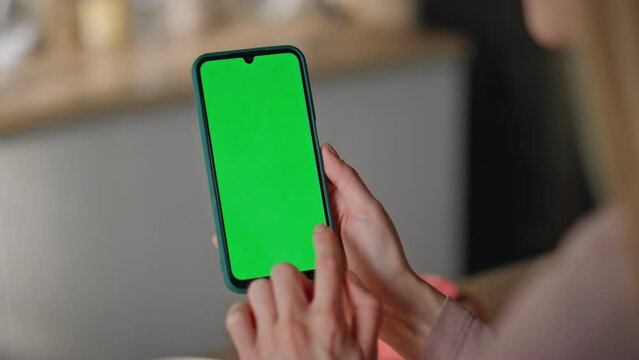 Girl browsing app chroma key smartphone making online order at home close up.
