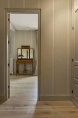 Anteroom with dressing room for double bedroom en suite with period wooden furniture with a beautiful wooden sideboard with a triptych of mirrors