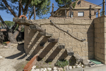 Exterior stairs of a detached house with wooden sleepers integrated into a curved wall on a...