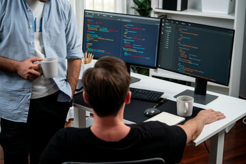 IT developers discussing online software development information on pc screen, creating program...