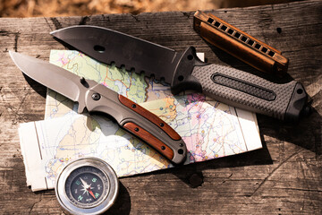 Camping kit for hiking in the wild, knife, map and compass with harmonica.