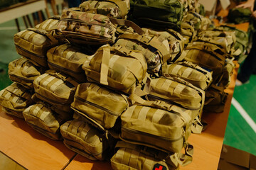 A group of military first aid kits on a table. Tactical first aid kits for the military