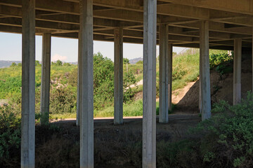 Concrete pillars under a freeway bridge