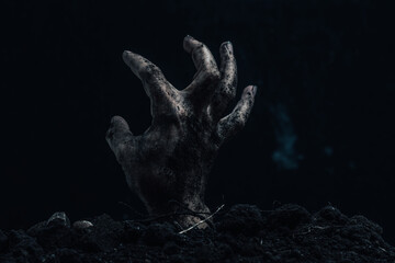 Scary zombie hand on a dark background. Horror Halloween concept.