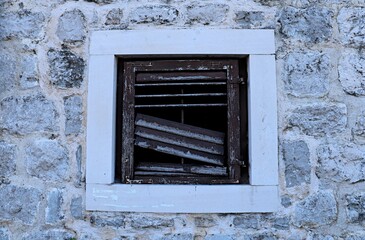 House window with broken blinds slats