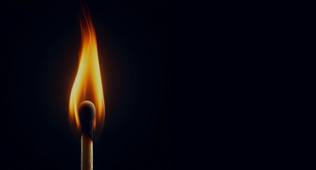burning match stick on black background