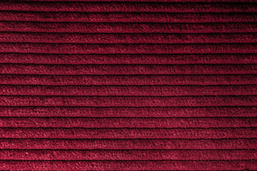 Closeup of red corduroy cloth as patterned textured background