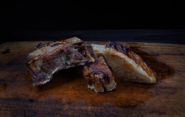 Roasted pork entrecote cut into pieces on a wooden cutting board. Grilled pork entrecote. Pork steak.