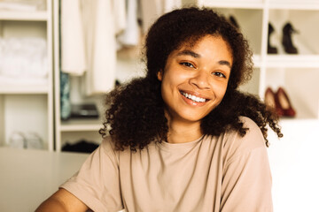 A close-up portrait of a young smiling teenage girl of mixed race in a home dressing room. A young...