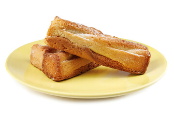 Several delicious crispy cookies lying on a yellow plate isolated on a white background.