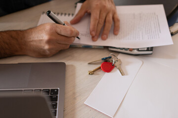 Real state agent signing a document .Business concept .New home keys.
