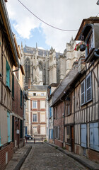 Beautiful street with traditional French buildings with wooden beams and colorful, surroundings of La Cathédrale Saint-Pierre, Beauvais, France.