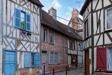 Beautiful street with traditional French buildings with wooden beams and colorful, surroundings of...