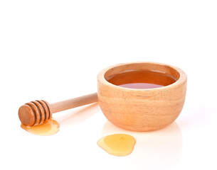 Honey in wooden bowl and honey Dipper on white background