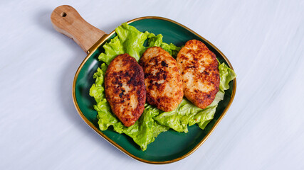 Chicken cutlets on plate top view