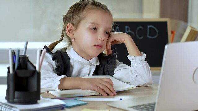 Cute kid studying hard, asleep lazy school girl yawning