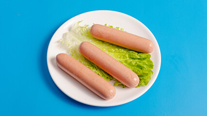 Boiled sausages on plate