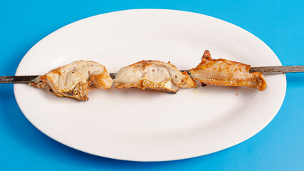 Chicken kebab skewers on plate top view