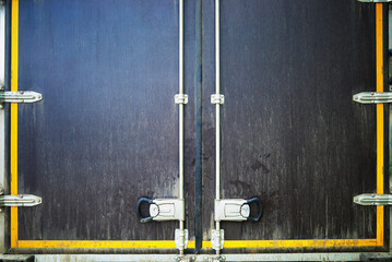 Closed dirty doors of delivery truck transportation delivery backdrop