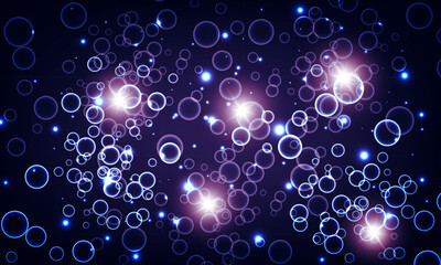 Blue bubbles and water with bright light on dark background.