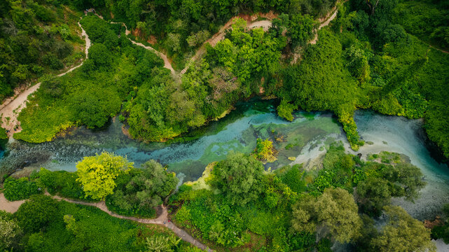 Beautiful turquoise spring Blue Eye or Syri i Kalter near Muzine town in Albania. The spring is very powerful, cold and deep and is a source of a river Bistrice. Tourist attraction of Albania