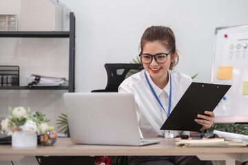 Young business woman meeting on laptop, doing paperwork in white office room