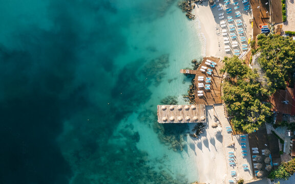 Sun umbrellas and loungers on the beautiful beach of Ksamil, Albania