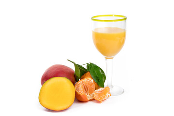 a cut mango and a peeled orange with a glass of orange and mango juice isolated on whit