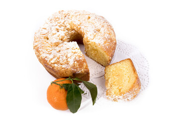 a round orange cake with a crumble top and a slice cut out isolated on white