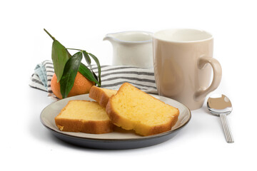 slices of orange loaf cake on a plate with a leaf orange and a cup of coffee in the background isolated on white