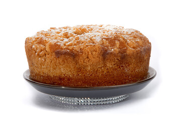 a round orange cake with a crumble top isolated on white