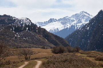 Snow-Capped mountain and Countryside Road. Natural mountains landscape. Pyramid hill. Spring nature in kyrgyzstan, hiking trail