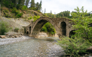 Fototapeta na wymiar The Old Mes bridge near Shkoder. Albania, Europe. Ottoman stone arch bridge Ura e Kadiut