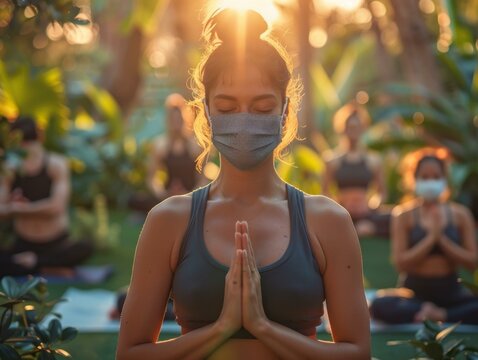 A group of people doing yoga in a park