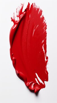 Close-up image of red oil paint on white background