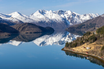 Fototapeta premium Panoramic drone view of Holandsfjord and Nordfjord in Nordland county. In the background is the Svartisen glacier, Norway's second largest glacier