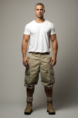 muscular man in white shirt and cargo pants